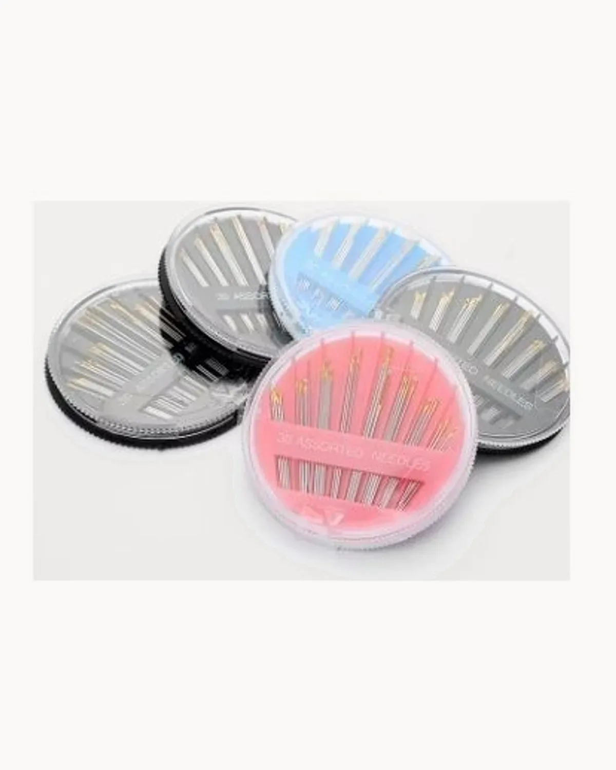 Round compact cases of assorted hand-sewing needles in pink, blue and black