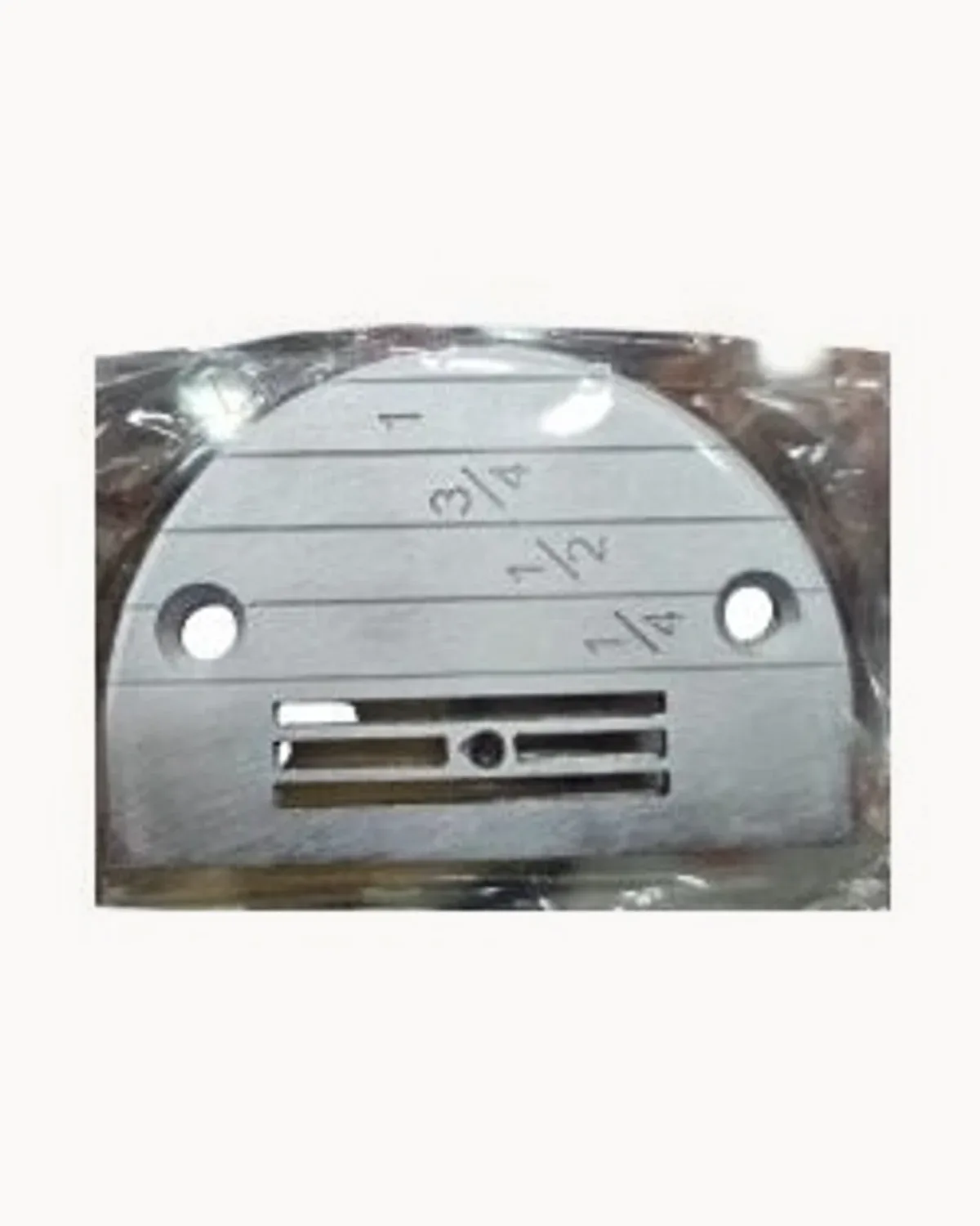 A bagged steel needle plate marked with quarter, half and three-quarter inch guides