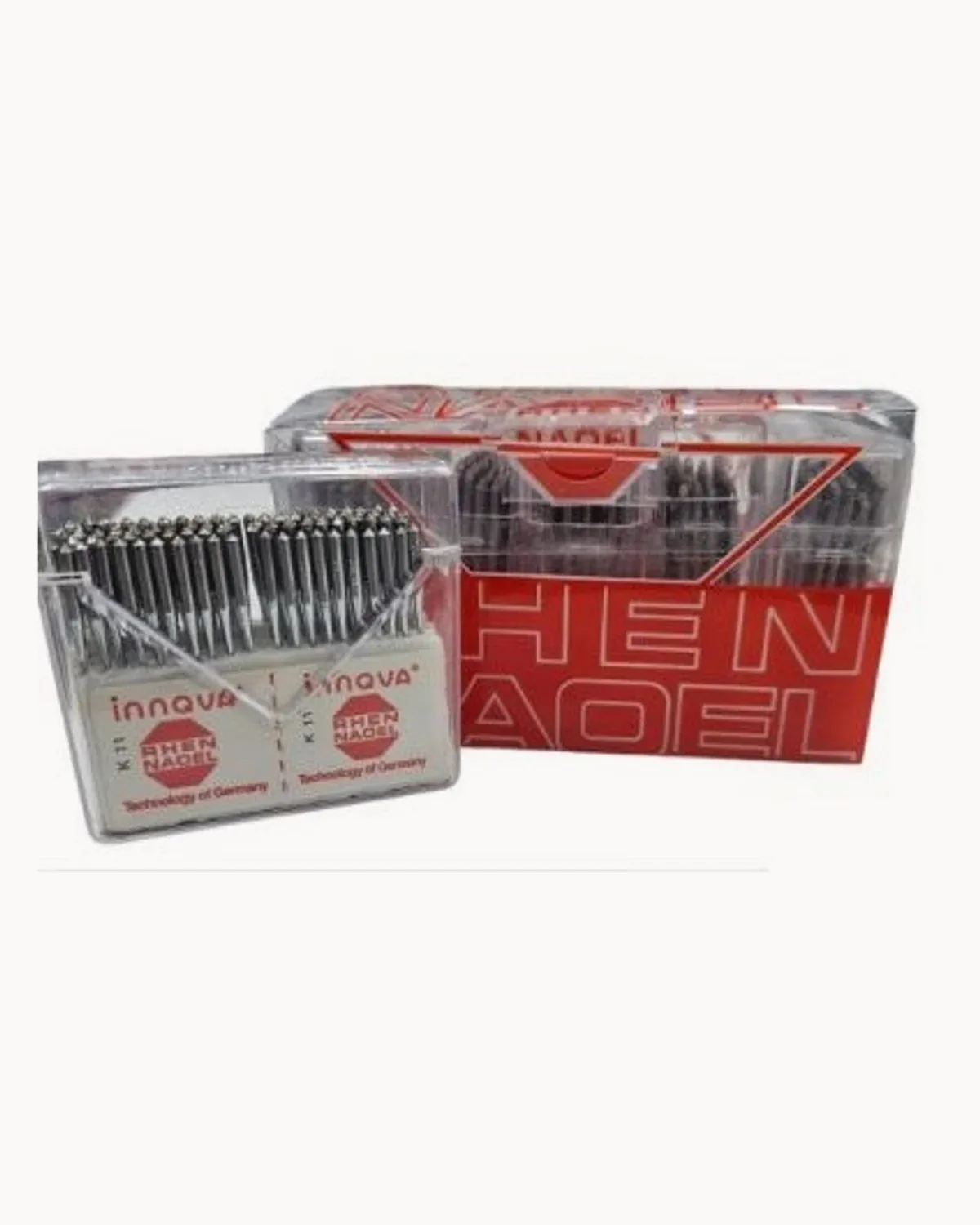 Two clear boxes of overlock machine needles beside their red carton
