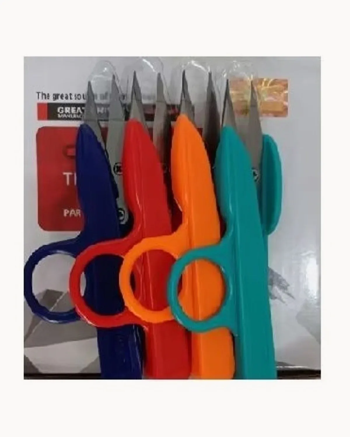 Boxed plastic-handled thread snips in blue, red, orange and teal