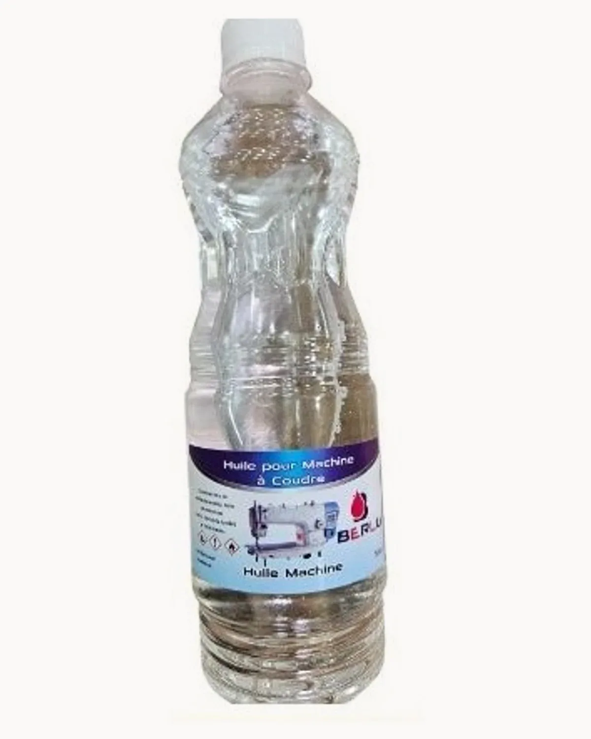 A 60 cl bottle of clear sewing machine oil