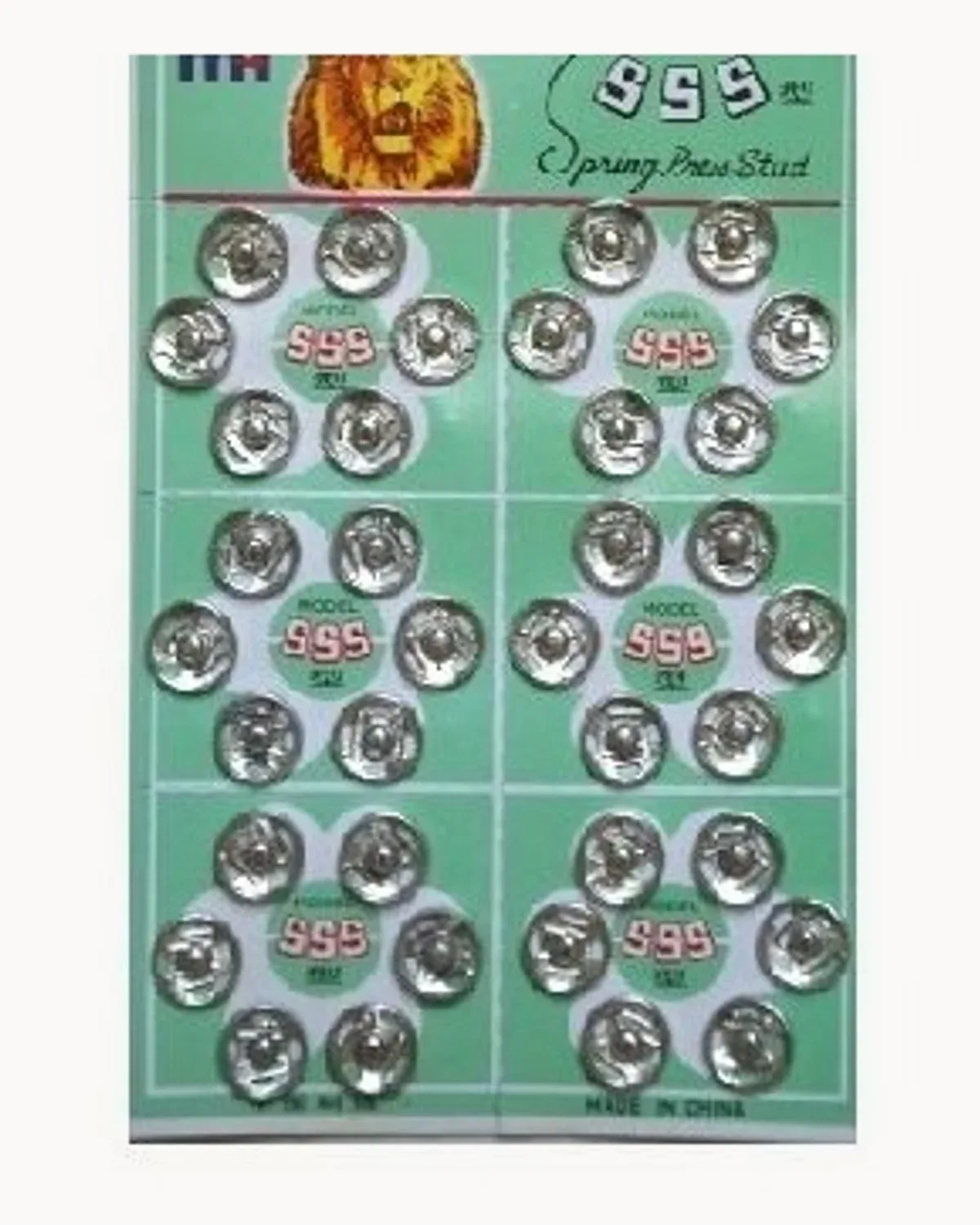 A green card of silver spring press studs arranged in rows